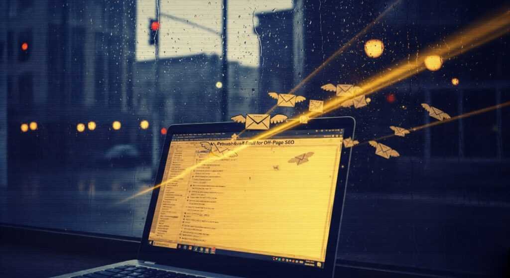 Laptop with emails reflected in rainy coffee shop window